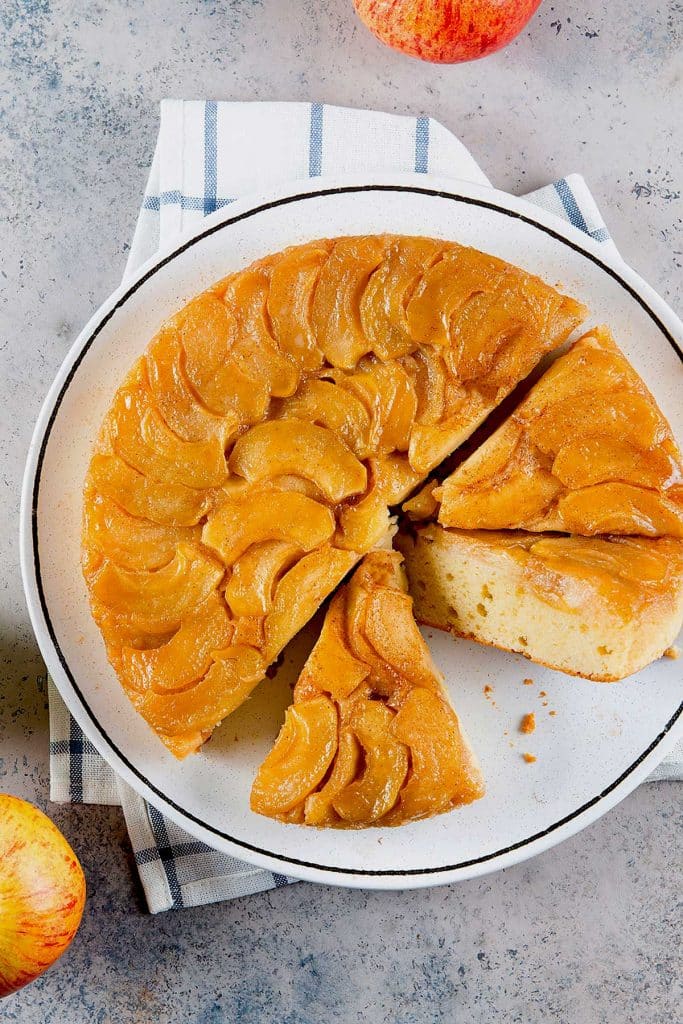 Pineapple upside down cake sliced on a white platter