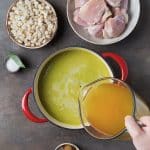 adding chicken broth to the green sauce