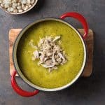 green pozole with shredded chicken on top