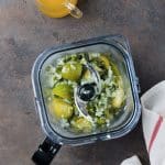 tomatillos and the green chile mixture in a blender