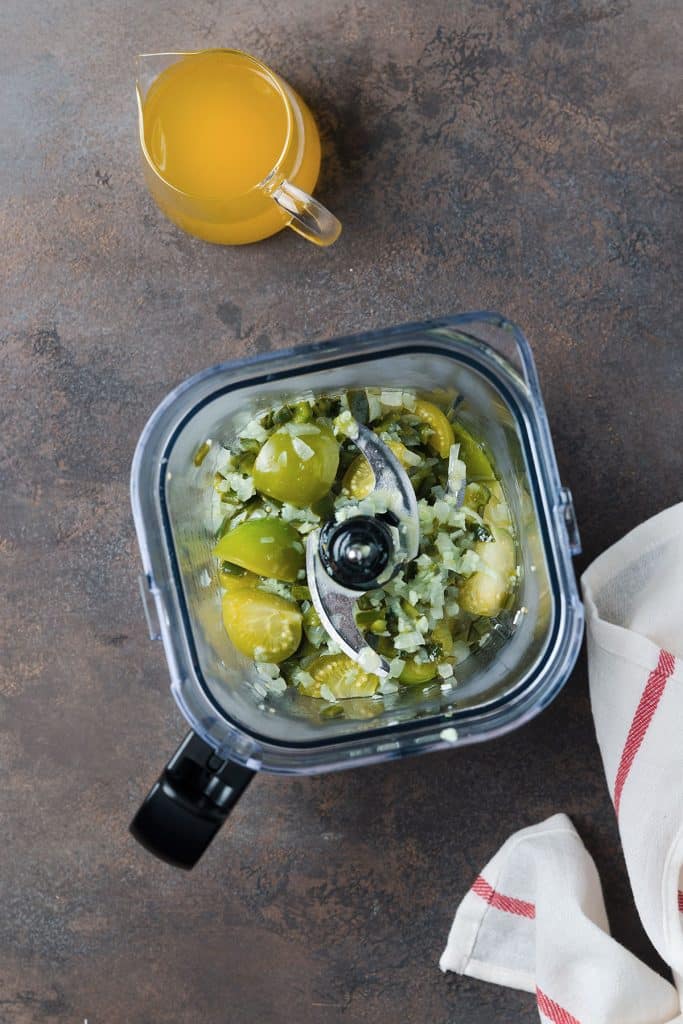tomatillos and the green chile mixture in a blender