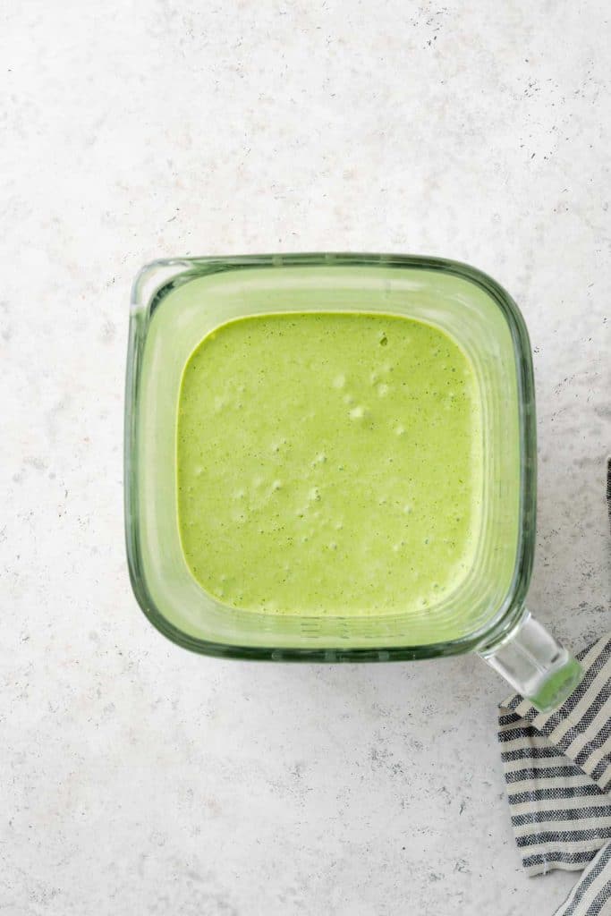 Smooth and creamy roasted poblano green sauce in a blender