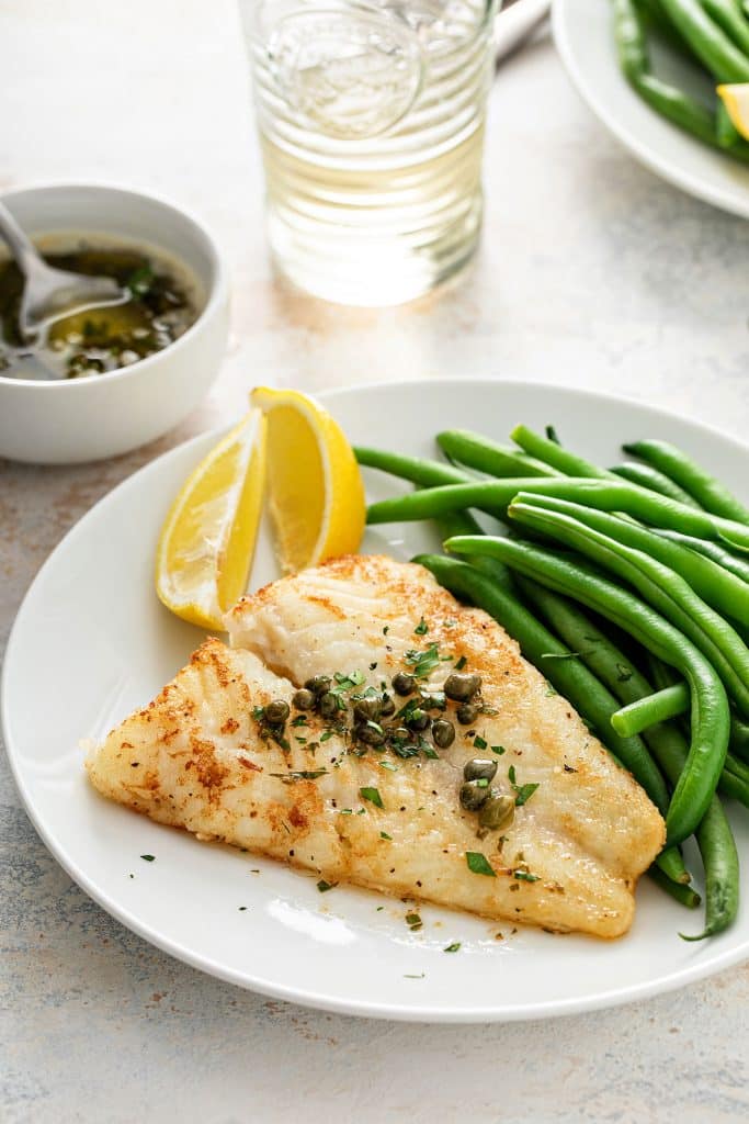 Serving of pan fred cod with capers and lemon butter 