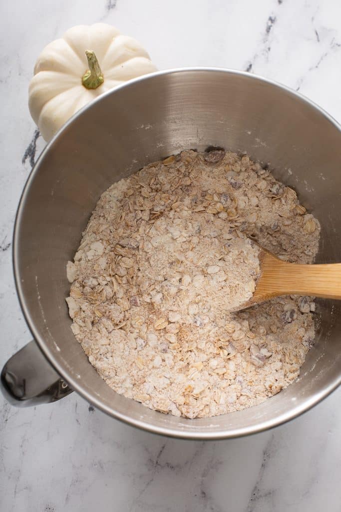 flour, oats, brown sugar, salt, baking soda, pumpkin pie spice, chopped pecans in the bowl of a standing mixer