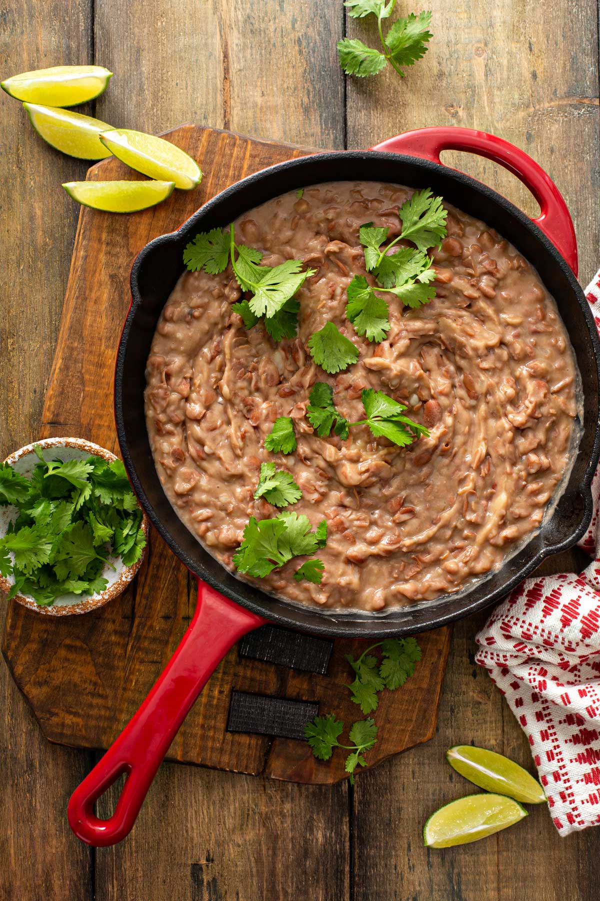 Refriend beans in a skillet topped with fresh cilantro