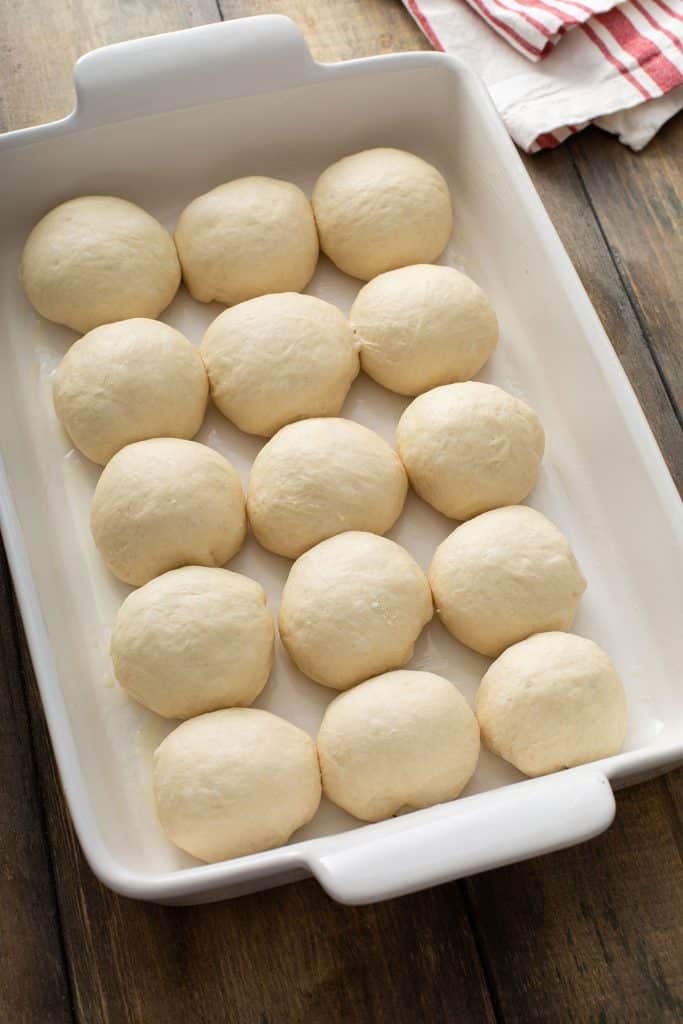 Dinner roll balls in a greased baking dish.