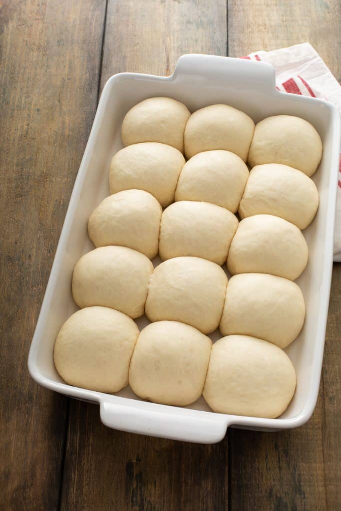Dinner rolls in a baking dish after second rise.