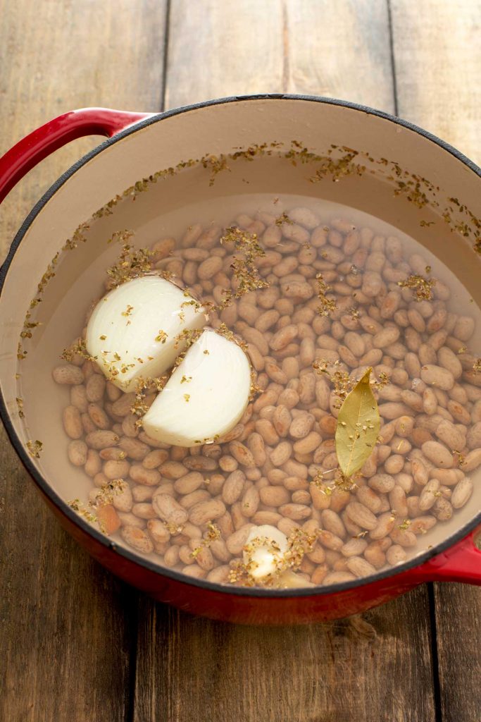 beans, onion, garlic and bay leaf in a dutch oven with water
