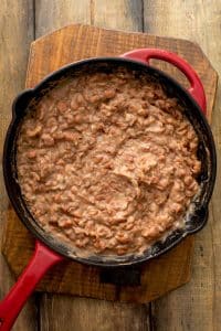 Frijoles refritos or refried beans in a skillet.