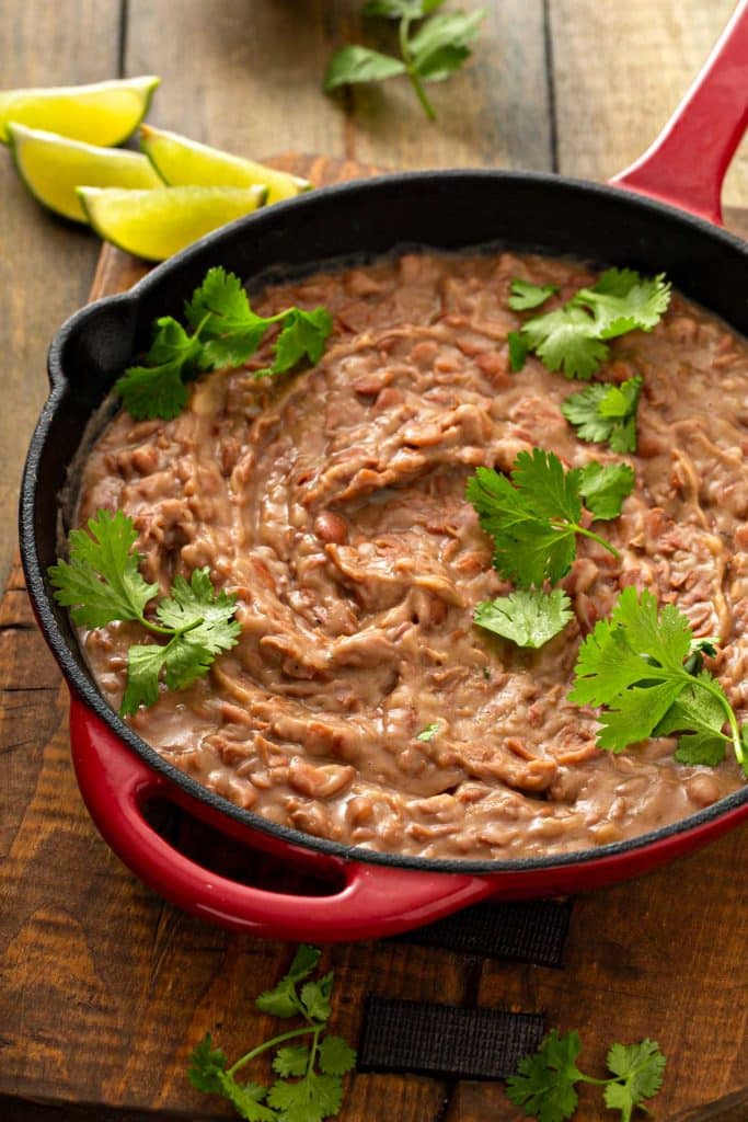 Refried pinto beans in a skillet.