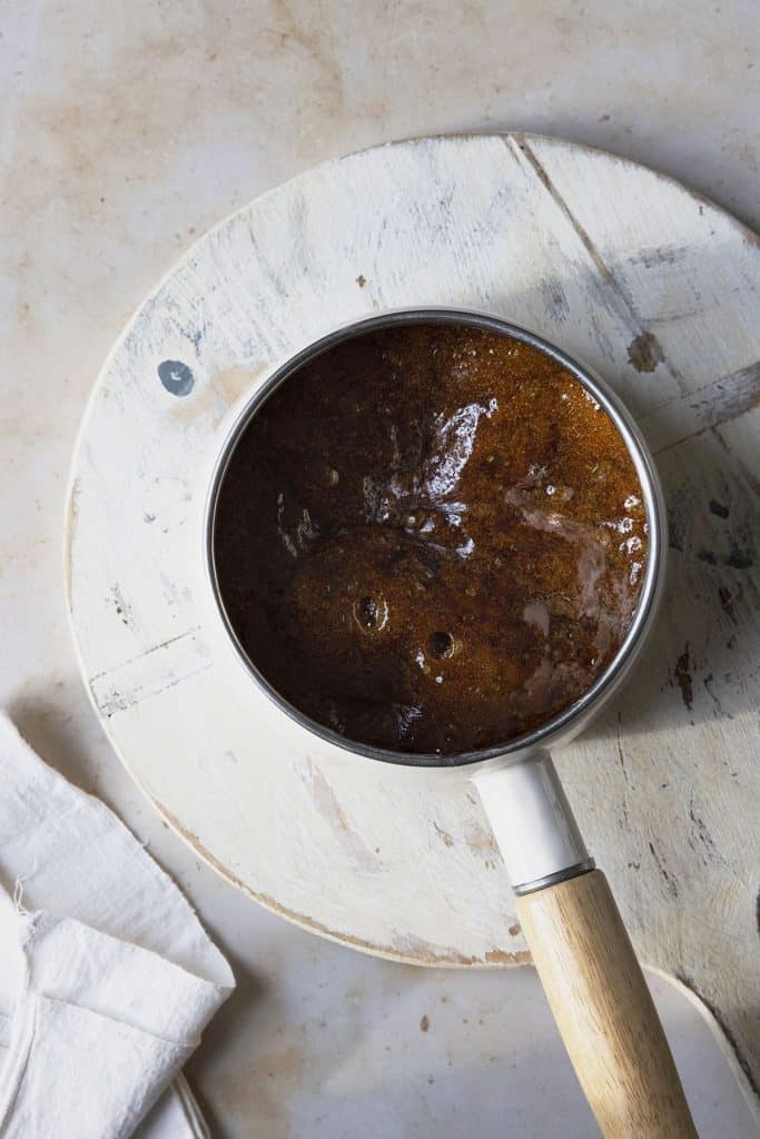 dark brown caramel sauce in a saucepan. 