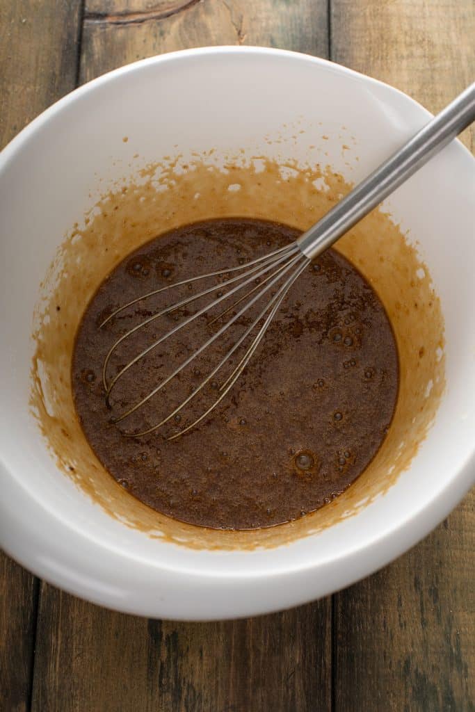 mixed eggs, brown sugar, corn syrup, vanilla extract, melted butter, bourbon and salt in a large mixing bowl with a whisk.