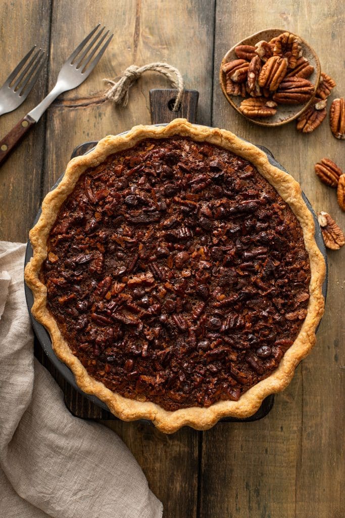 Top view of a baked chocolate pecan pie with golden brown edges.