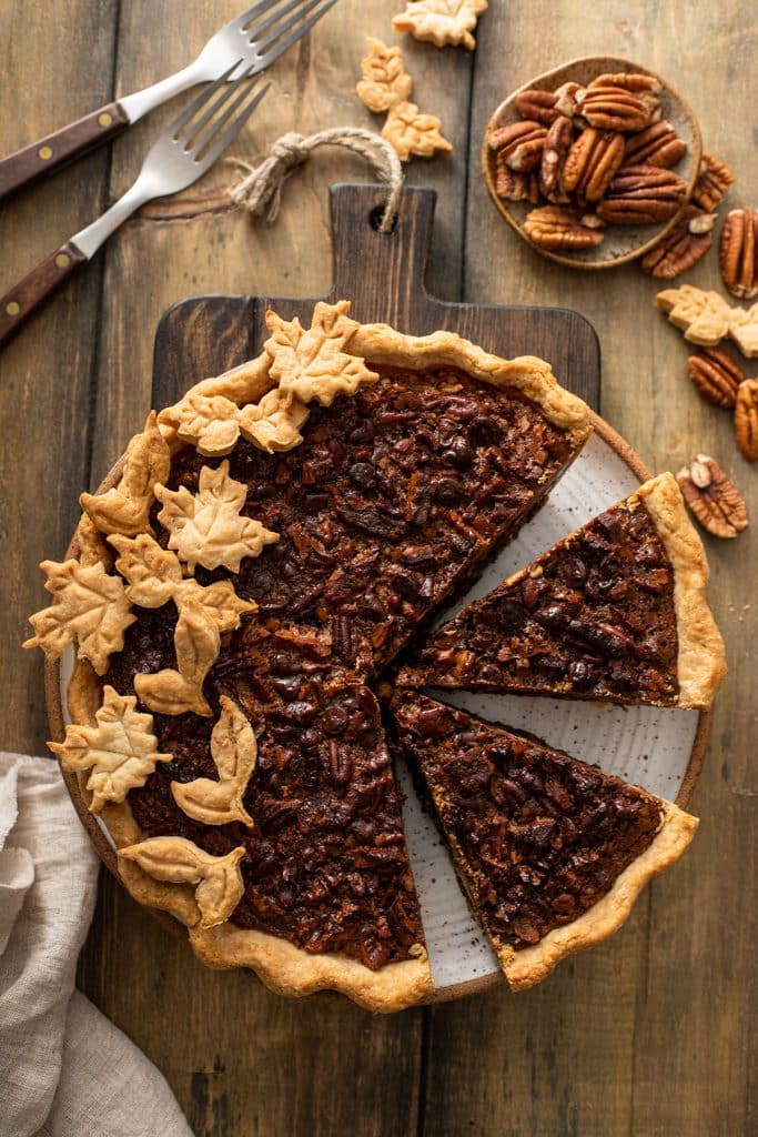 Top view of a Chocolate Pecan Pie with a few pieces cut out. 