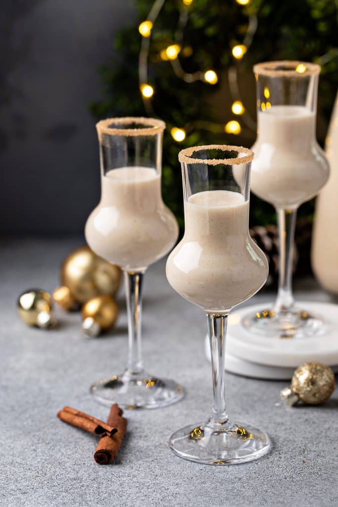 Three small glasses filled with creamy coquito cocktail