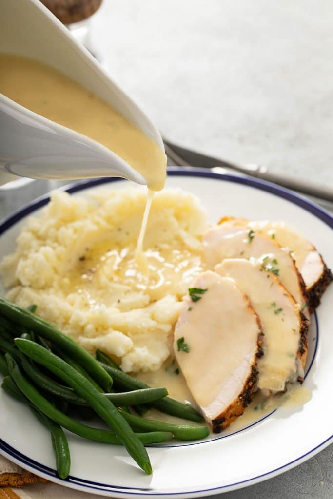 Gravy is poured over mashed potatoes