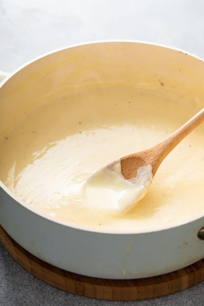 Super creamy mornay cheese sauce in a saucepan