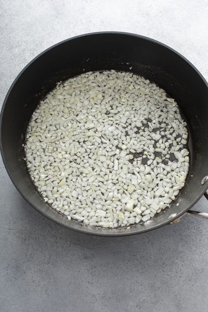 Sautéing diced onions in a skillet