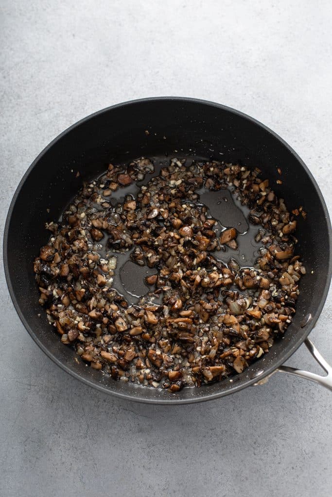Sautéing onions and mushrooms in a skillet