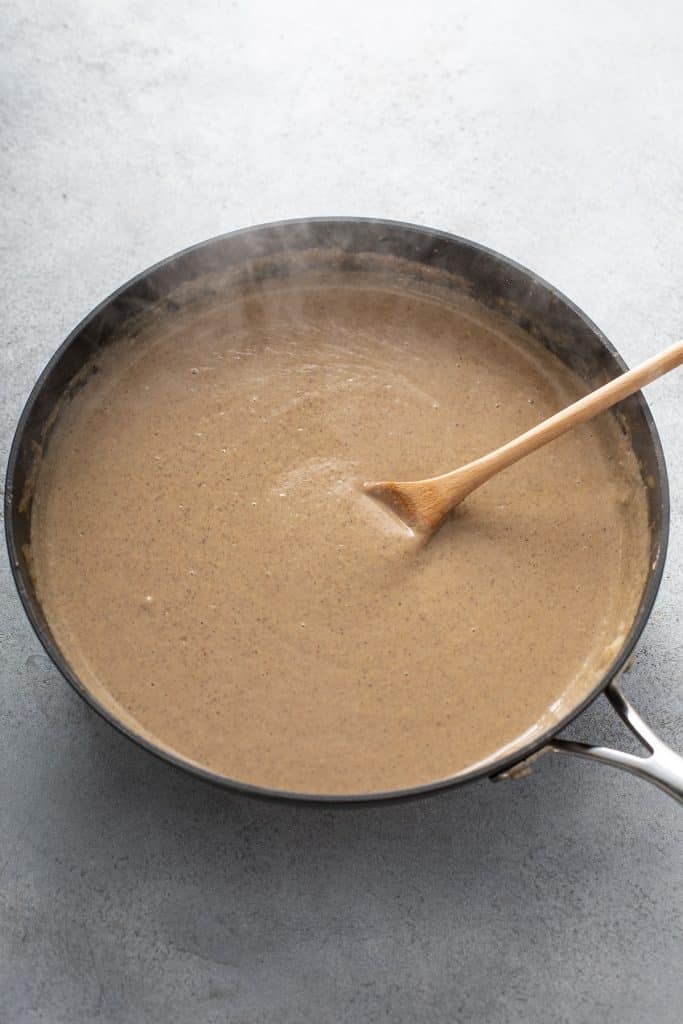 Smooth and glossy vegan gravy in a skillet