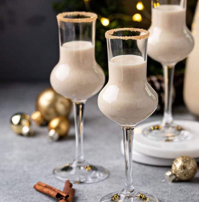 Three small glasses filled with creamy coquito cocktail