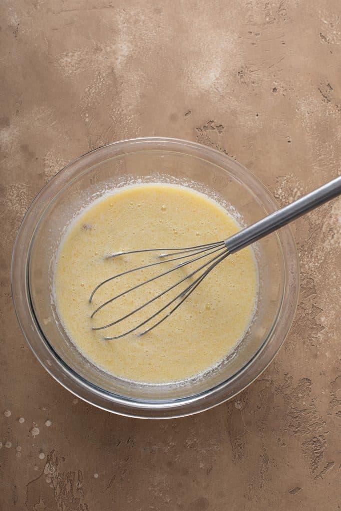 eggs, milk, vanilla, and melted butter whisk with the smashed bananas