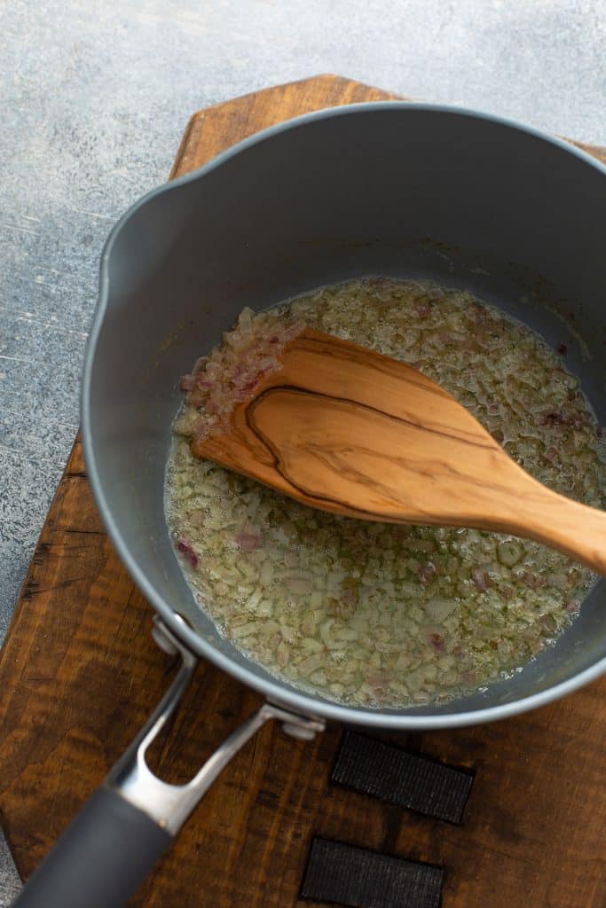 Melted butter in a pan with a wooden spatula.