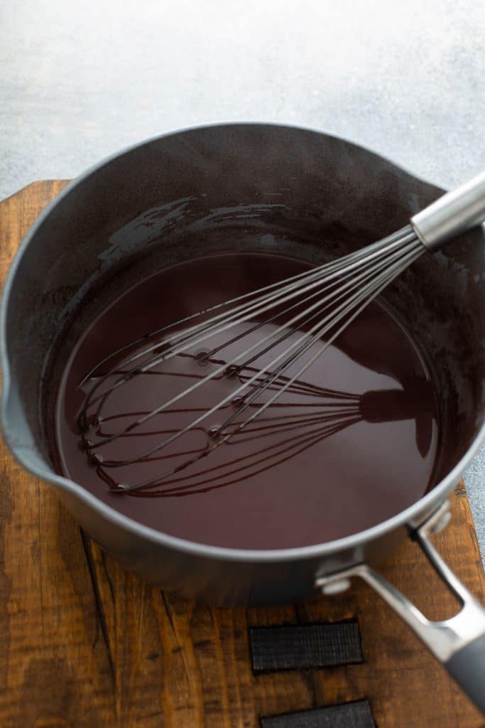 Wine sauce in a pan with a whisk.