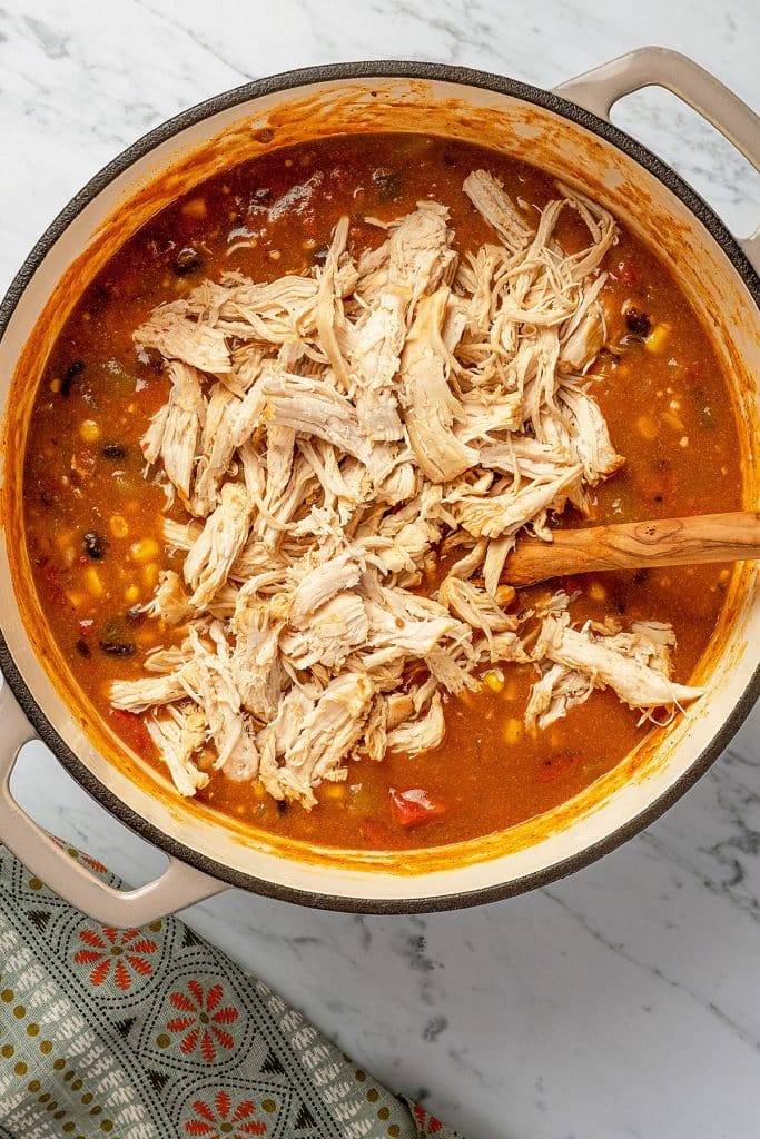 shredded chicken over the enchilada soup with black beans and veggies