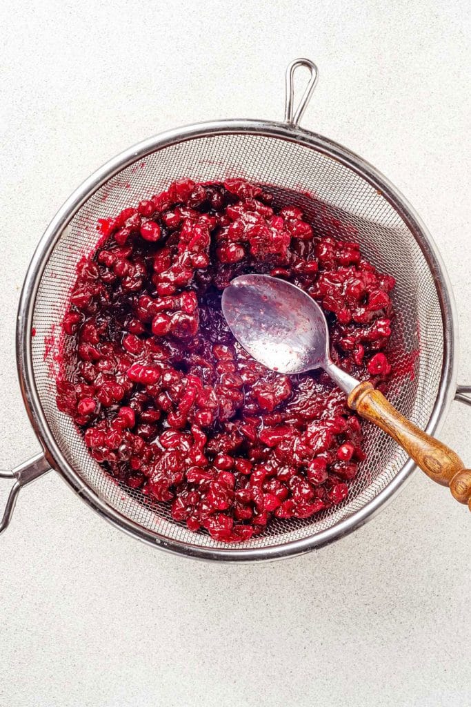 cranberry sauce in a colander 