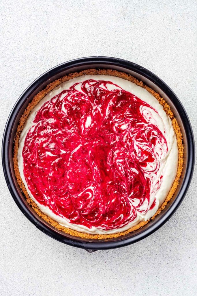 Swirls of cranberries on cheesecake