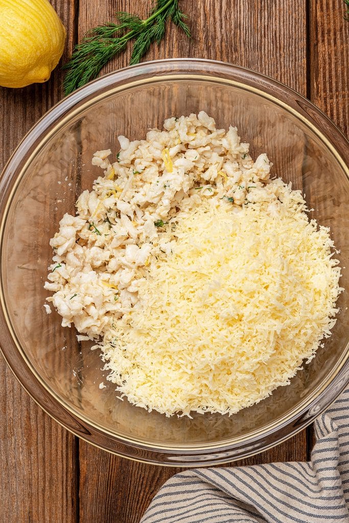 Crab meat and shredded cheese in a large mixing bowl