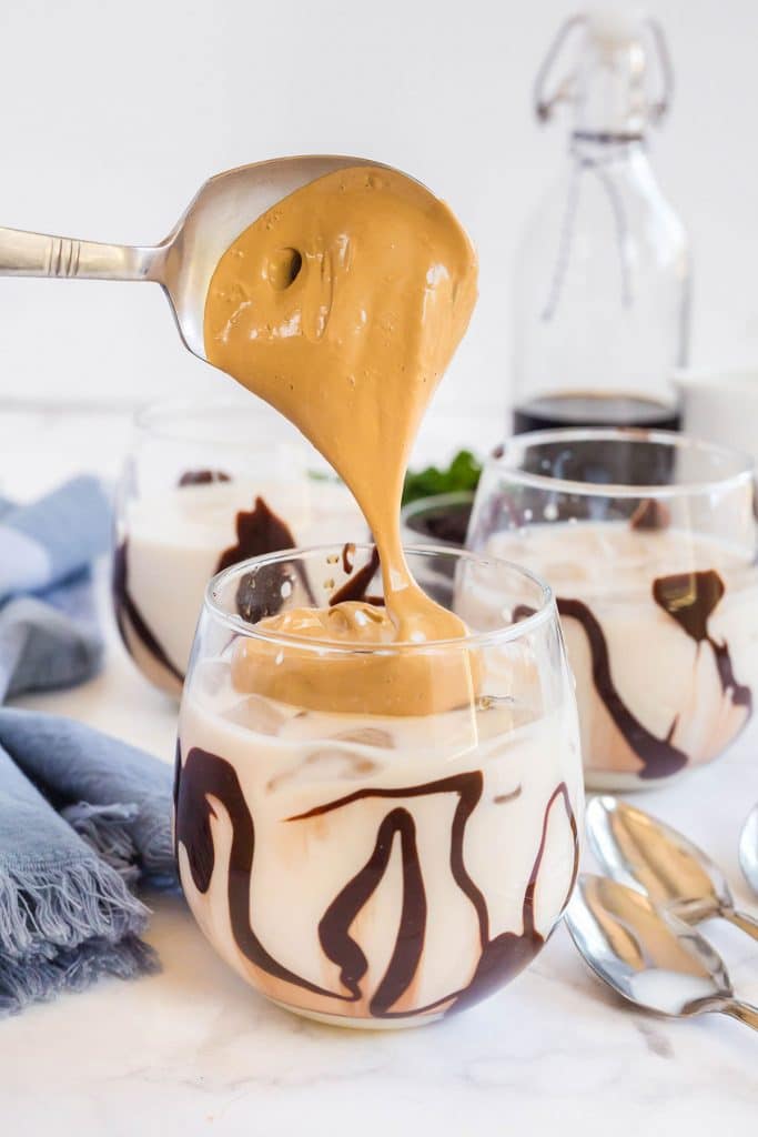 pouring whipped coffee to a Chocolate drizzled glass with kahlua milk coffee