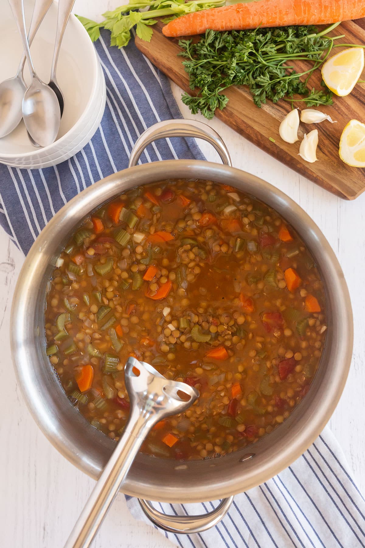 using an immersion blender to make the lentil soup creamier.