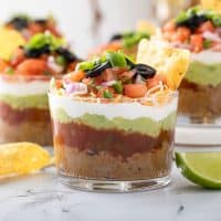 7-layer dip served in a plastic clear cup