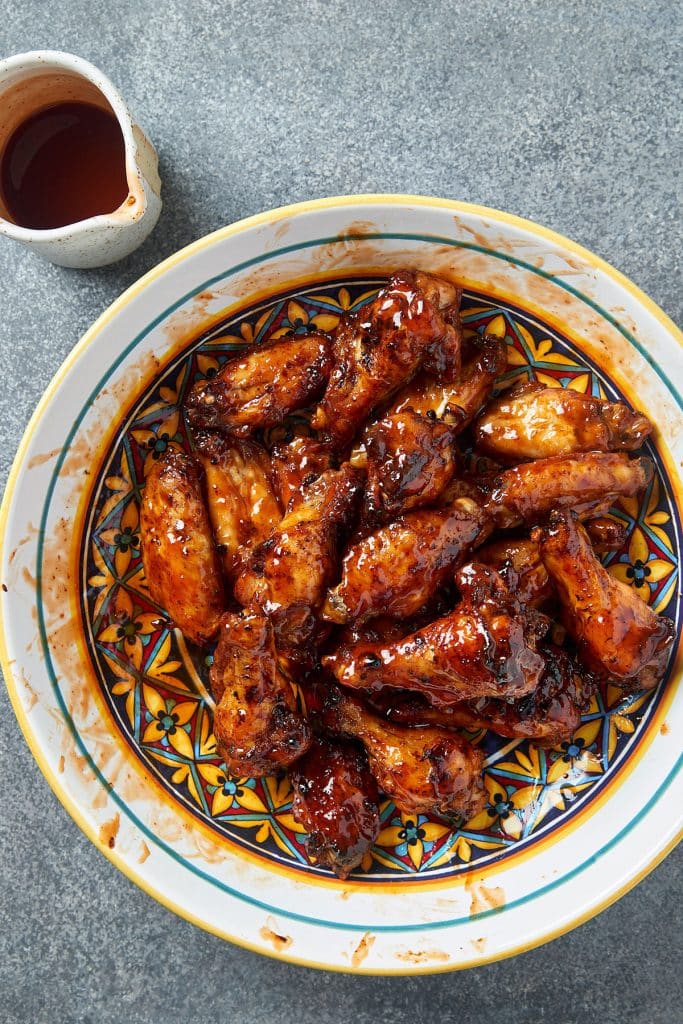 top view of crispy chicken wings with bbq sauce in a bowl