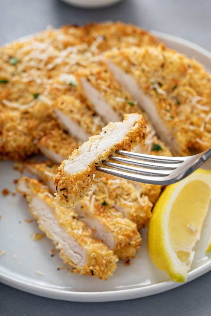 Close up view of juicy chicken coated in crispy panko breading