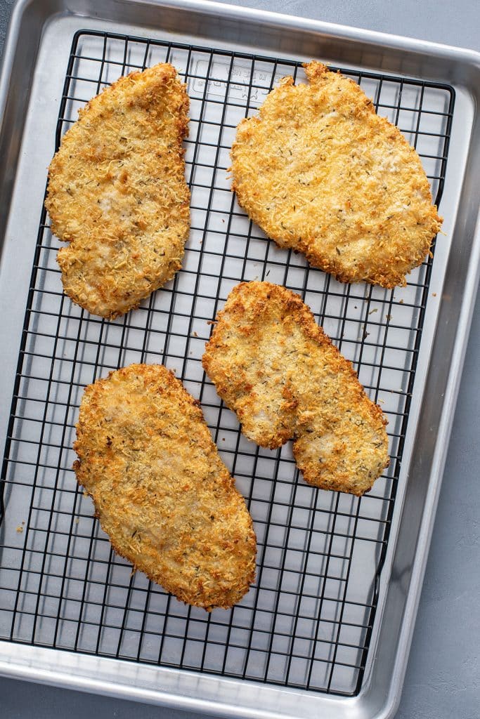 Crispy and golden brown chicken cutlets on a wire rack