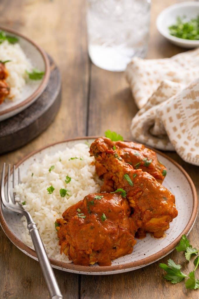 Chicken legs and thighs in a creamy Indian curry served with rice.