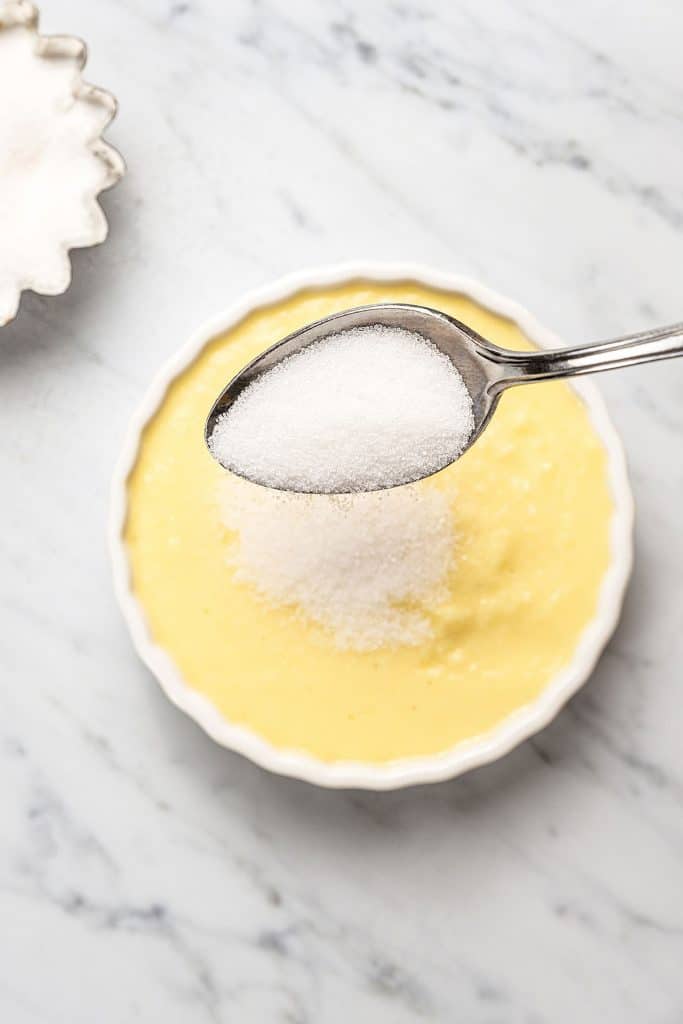 sprinkling granulated sugar all over the top of a custard