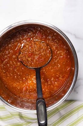 scooping texas chili from an instant pot
