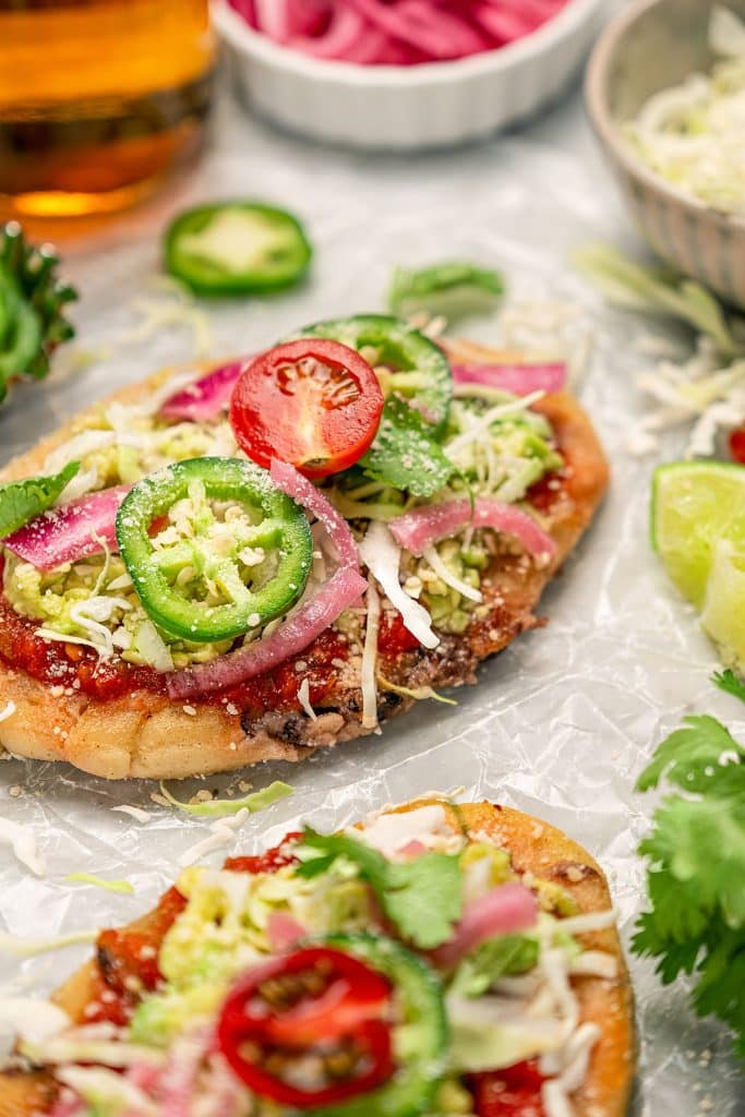 Golden brown crispy tlacoyos served with toppings