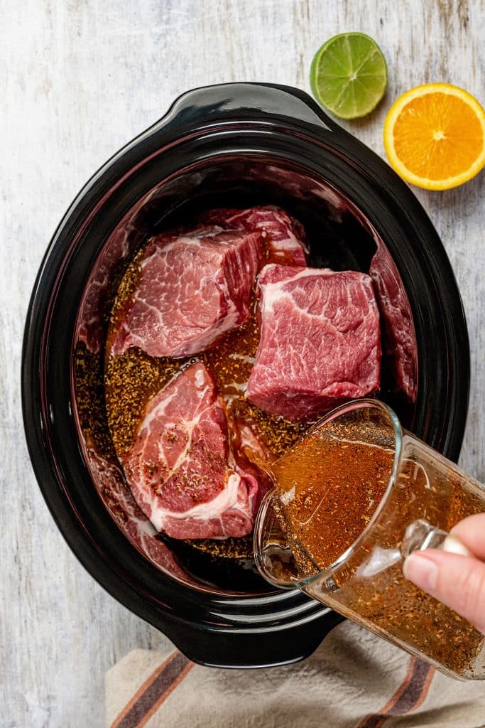 pouring the liquid seasoning mixture over the pork chunks