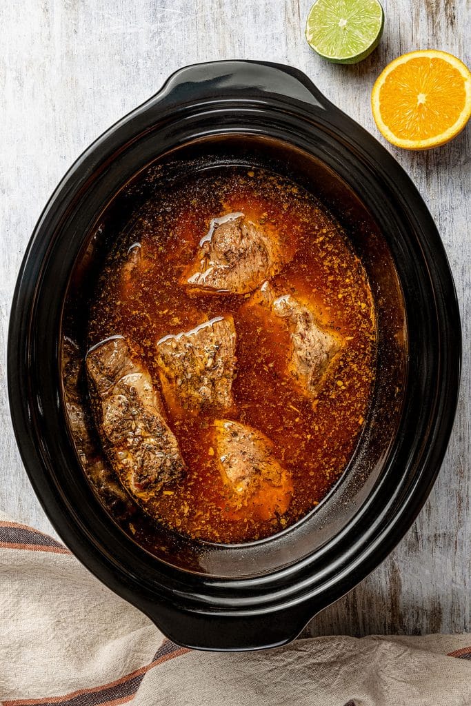 cooked pork shoulder chunks in a crockpot.