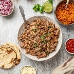 top view of a bowl with slow cooked pork carnitas