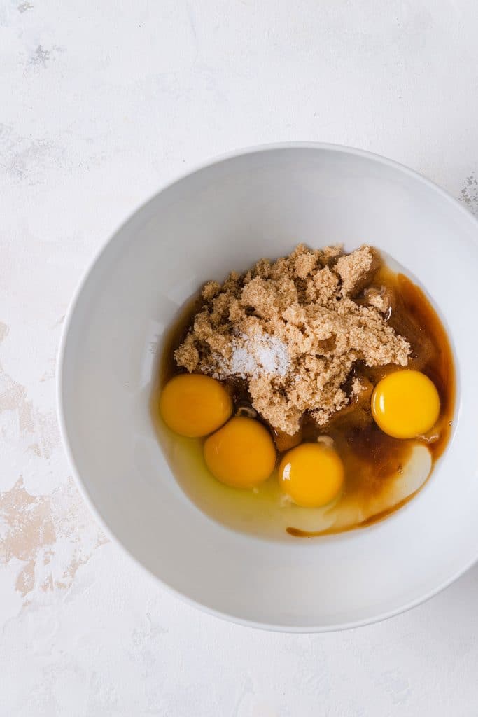 Eggs, light brown sugar, vanilla extract and salt in a mixing bowl.