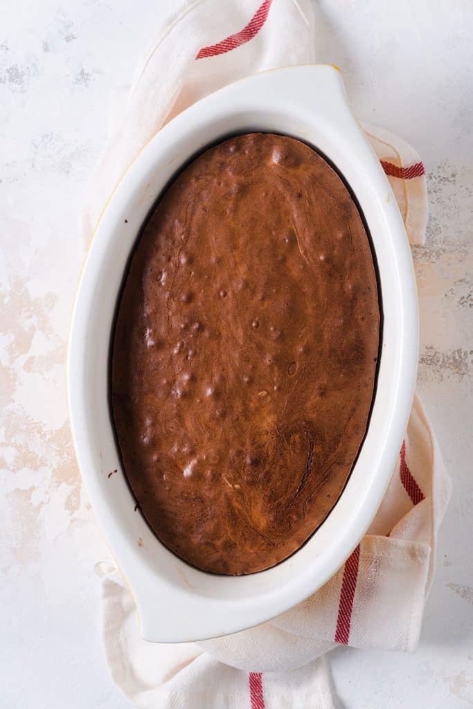 Baked brownie pudding in an oval baking dish