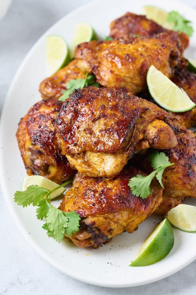 Pollo asado pieces served on a white plate