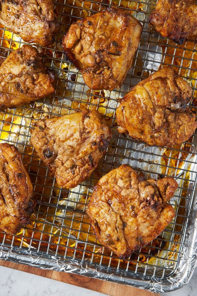 Golden brown roasted pollo asado on a wire rack