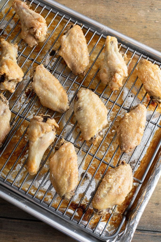 broiled chicken wings on a baking sheet